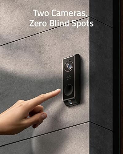 Person reaching for a smart doorbell with two cameras for home security